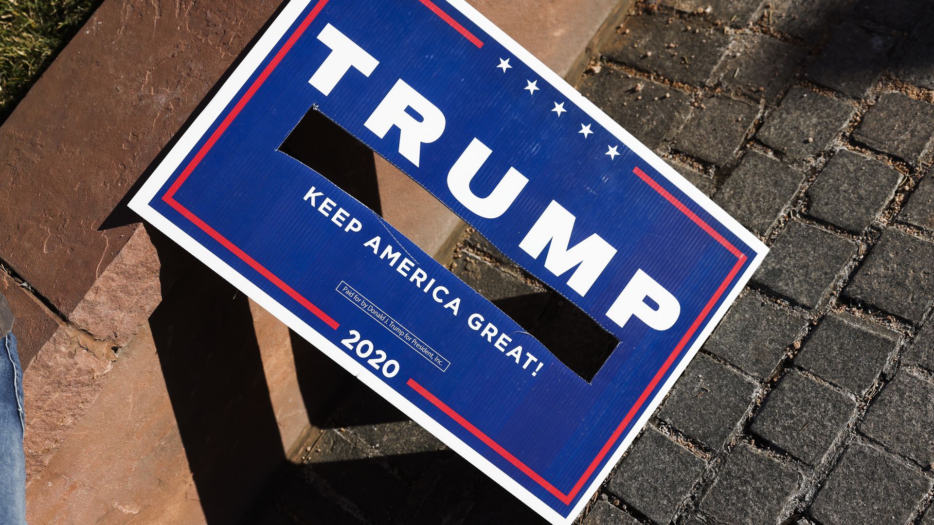   A Trump sign with Vice President Mike Pences name removed sits next to the Colorado State Capitol as Trump supporters protest the election on January 6, 2021 in Denver, Colorado.