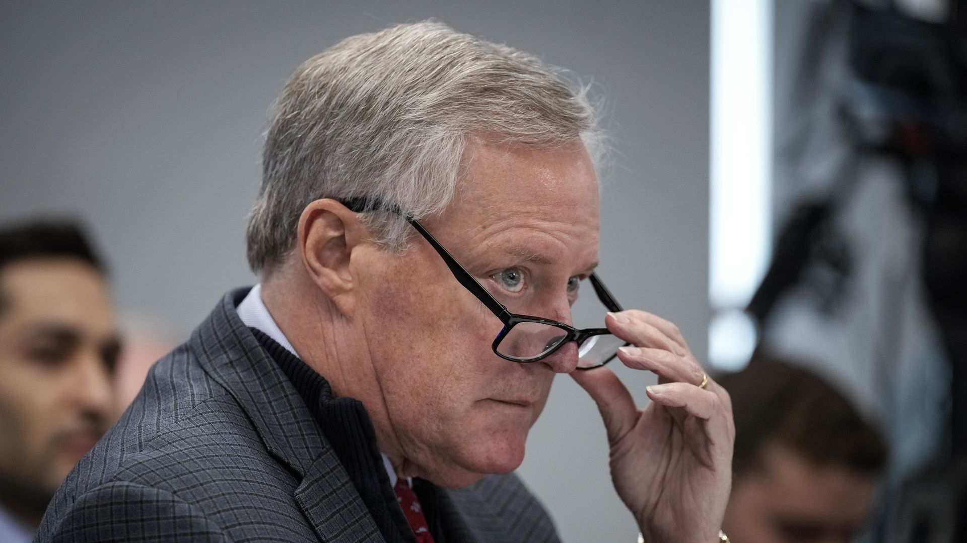 Mark Meadows lowering glasses and staring in a different direction from the camera