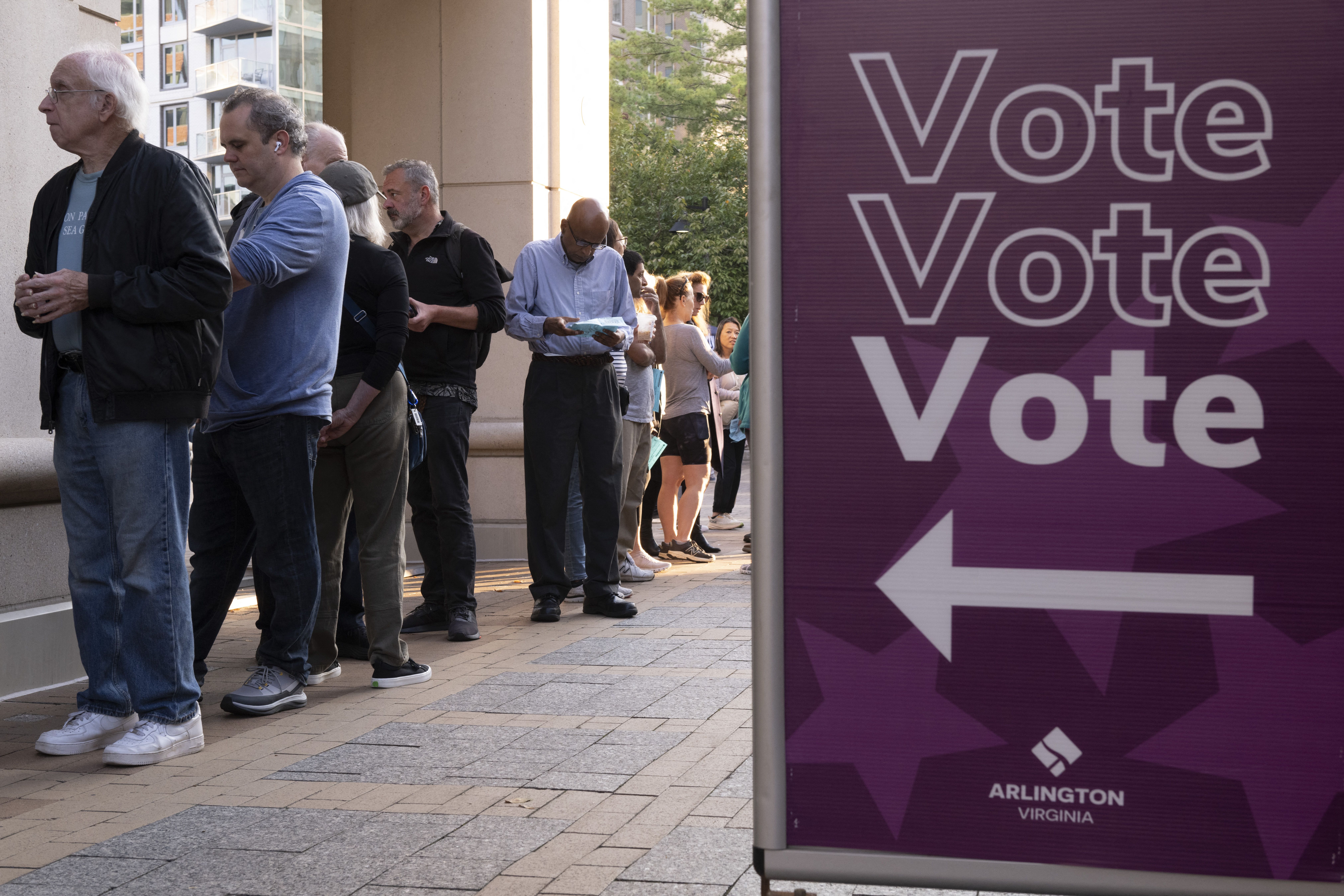Voters line up to cast their ballot as early voting starts in the US national elections in Arlington, Virginia, on September 20, 2024. Early in-person voting for the 2024 US presidential election began in Virginia, South Dakota and Minnesota. (Photo by AFP) (Photo by -/AFP via Getty Images)