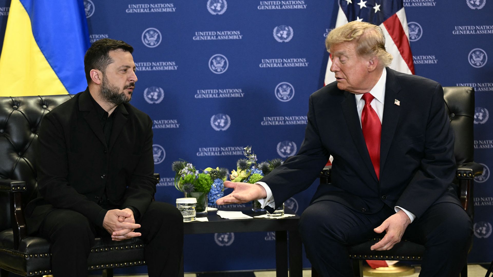 Ukrainian President Volodymyr Zelensky sits across from President Trump, who gestures with his hand during a meeting at the UN General Assembly.