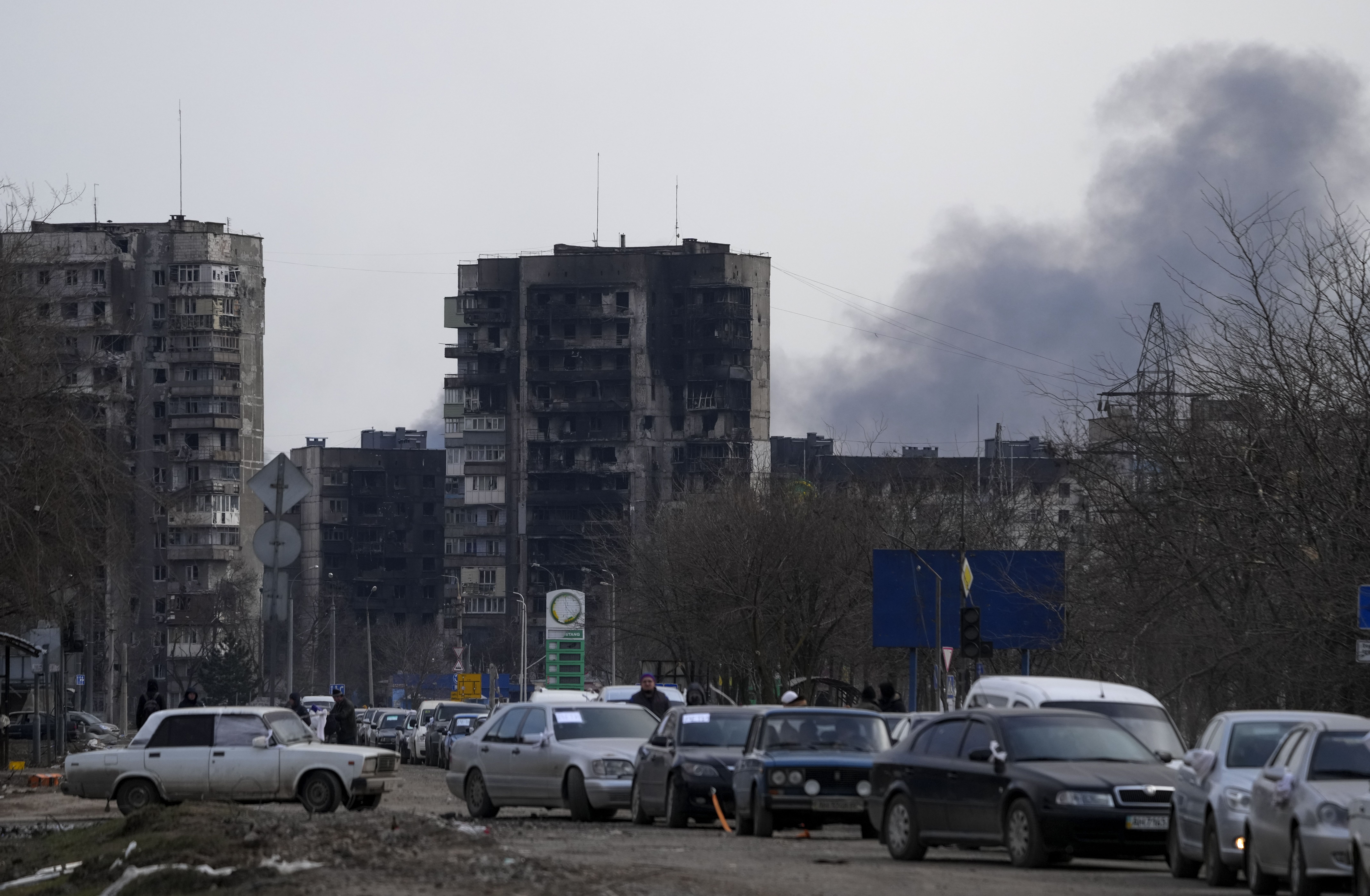 Smoke rises from behind Mariupol buildings as the city's civilians are evacuated in groups under the control of pro-Russian separatists on March 20.