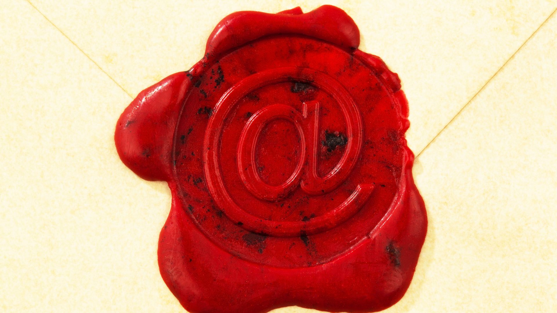 A wax seal marked with an "@" sign protects an letter.