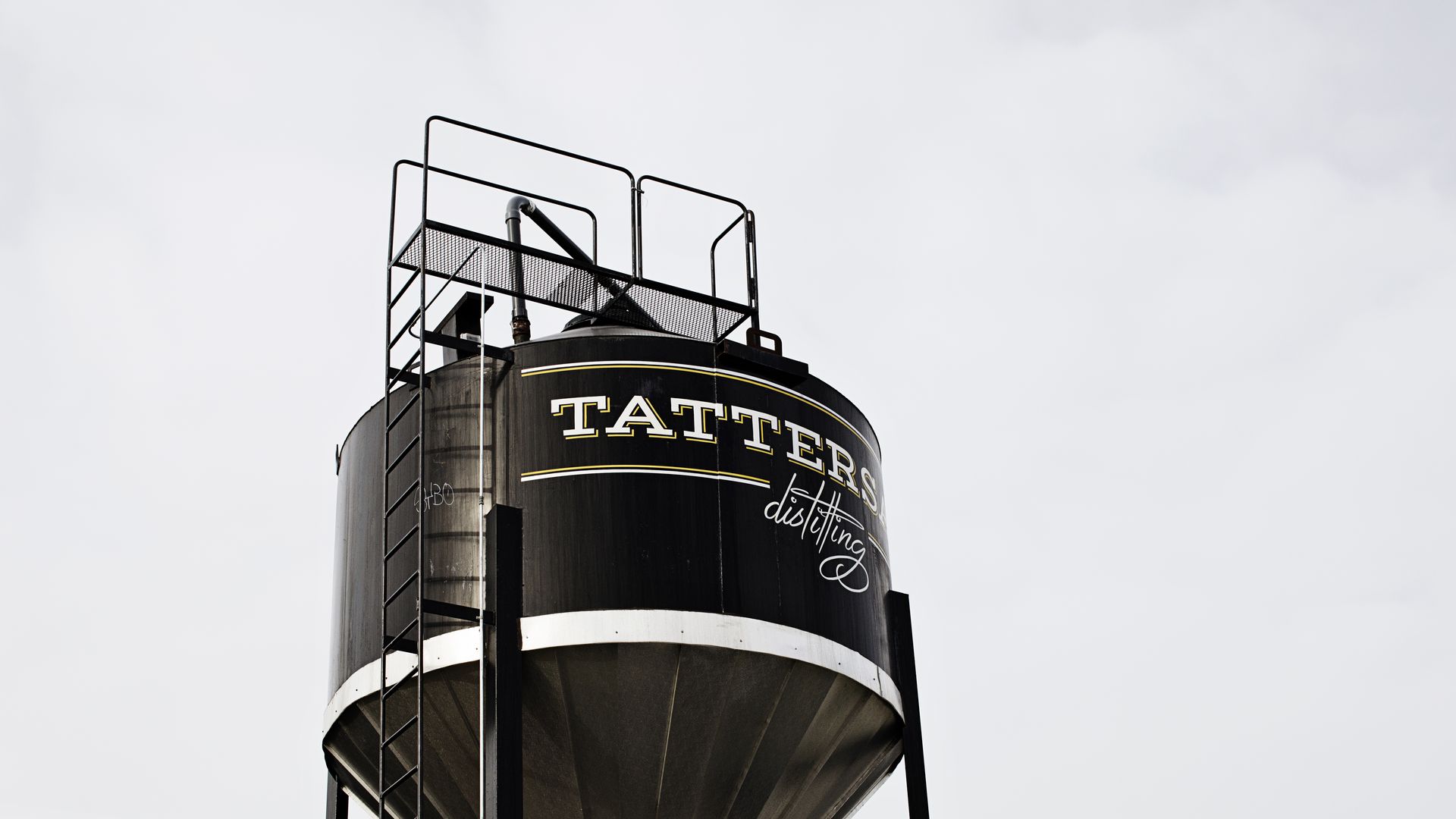 large drum on top of building with tattersall distilling written on side