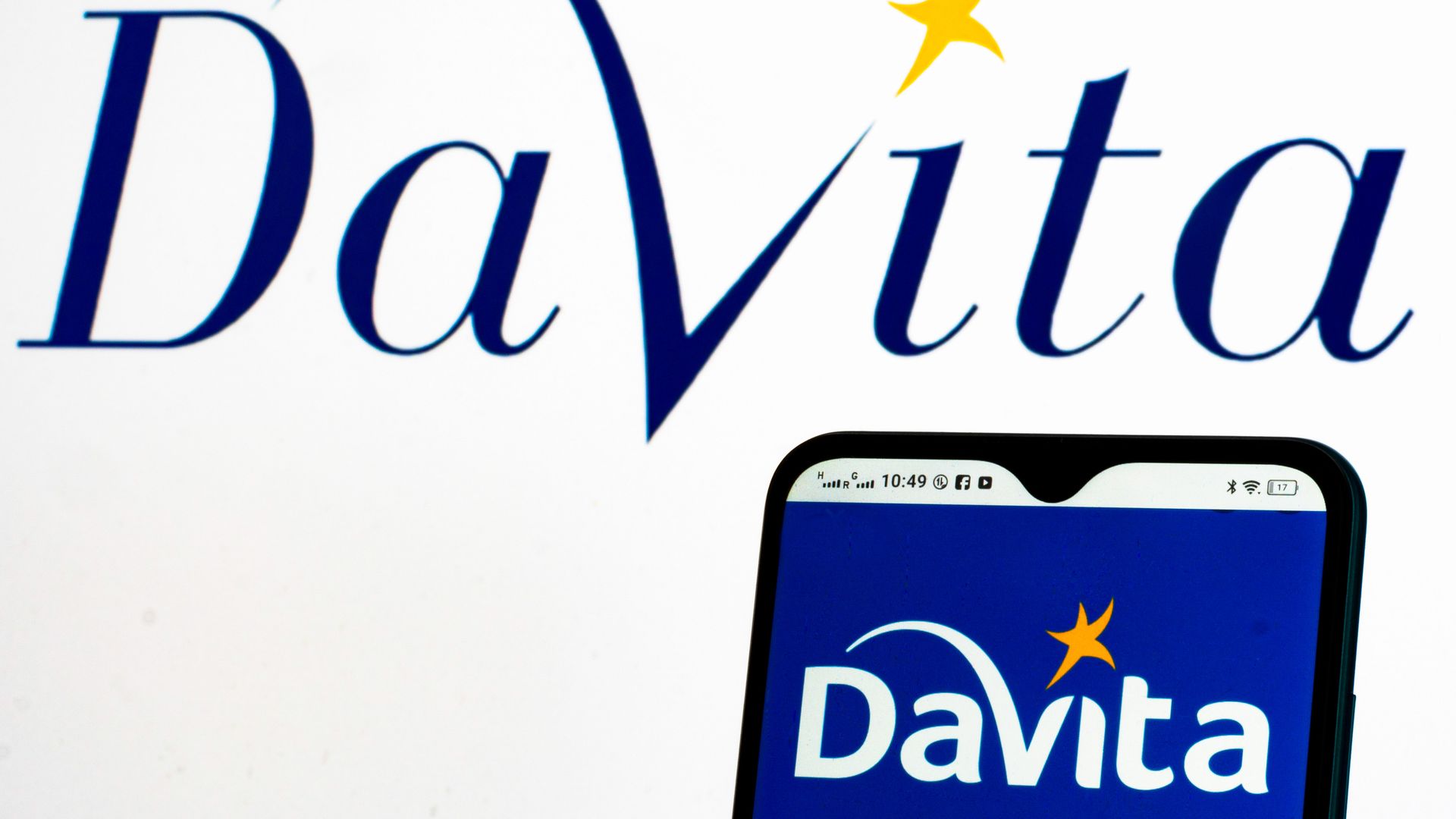 The DaVita logo on a blue background on a phone and on a white background.