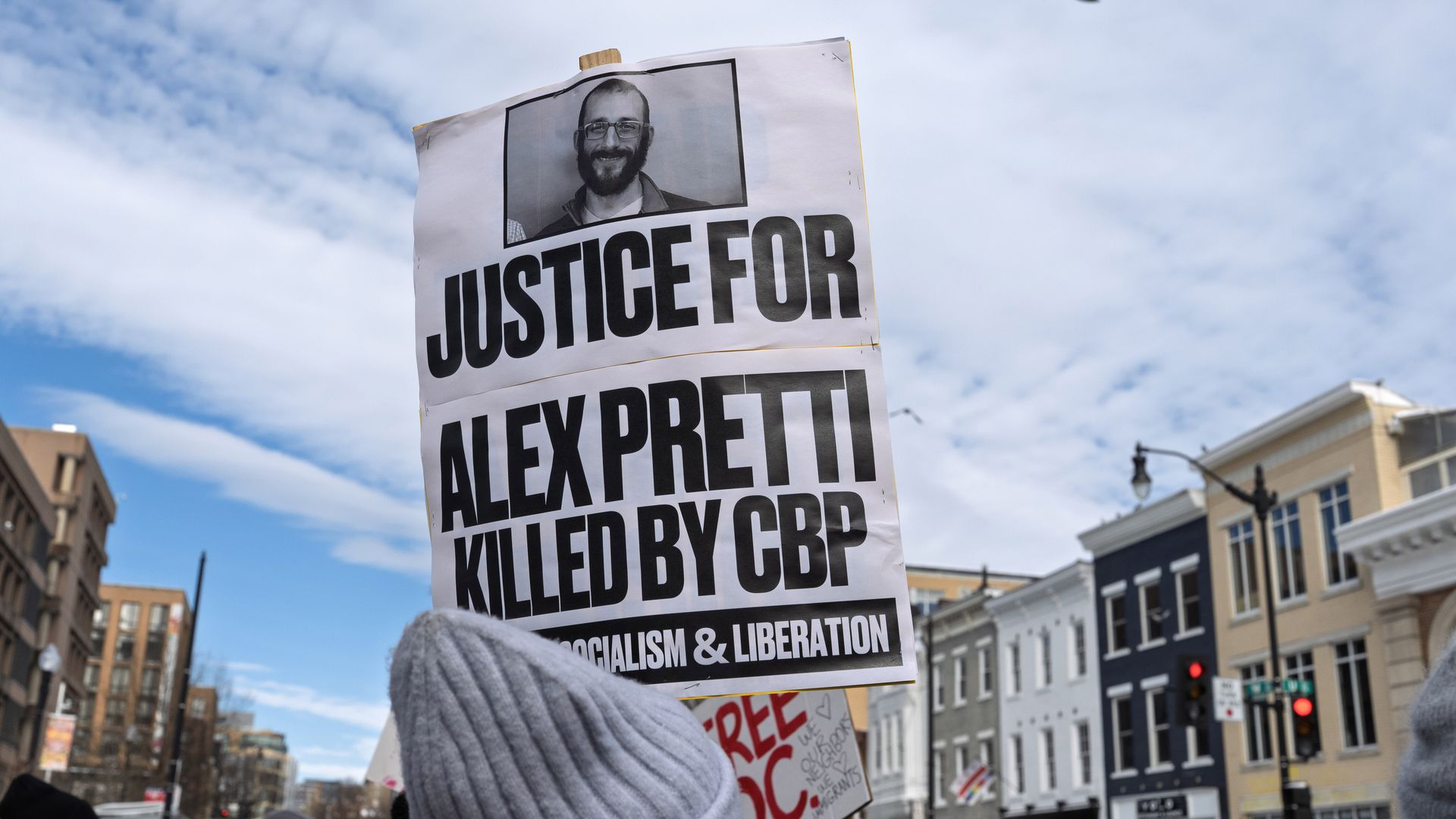 A demonstrator holds a sign reading "Justice for Alex Pretti, killed by CBP" during a protest in Washington, D.C., Jan. 26 