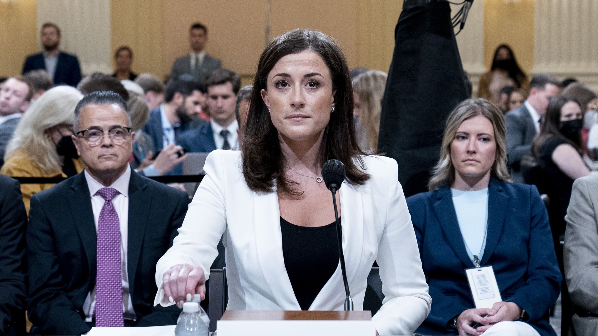 Photo of Cassidy Hutchinson sitting at a table in a hearing room