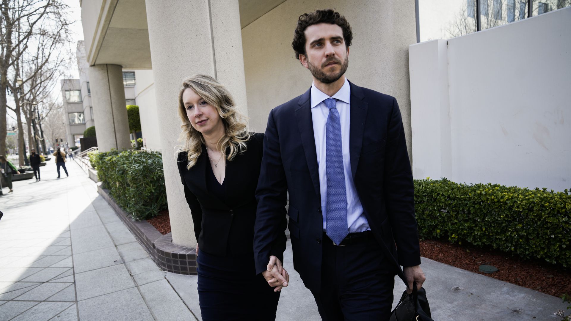 SAN JOSE, CA - MARCH 17: Former Theranos CEO Elizabeth Holmes alongside her boyfriend Billy Evans, leaves a hearing at the Robert E. Peckham U.S. Courthouse on March 17, 2023 in San Jose, California. Holmes appeared in court for a restitution hearing. (Photo by Philip Pacheco/Getty Images)