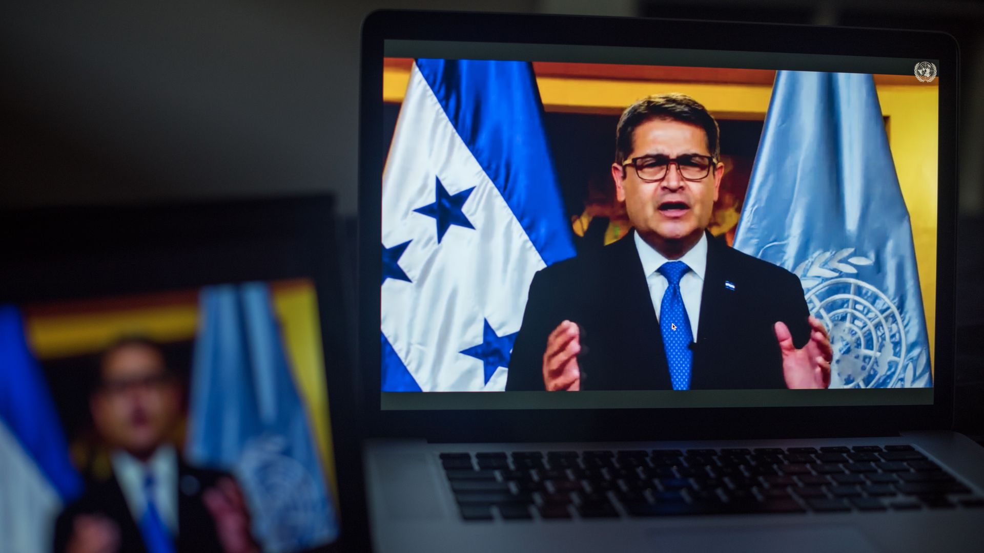 Juan Orlando Hernandez, Honduras' president, speaks during the United Nations General Assembly seen on a laptop computer.