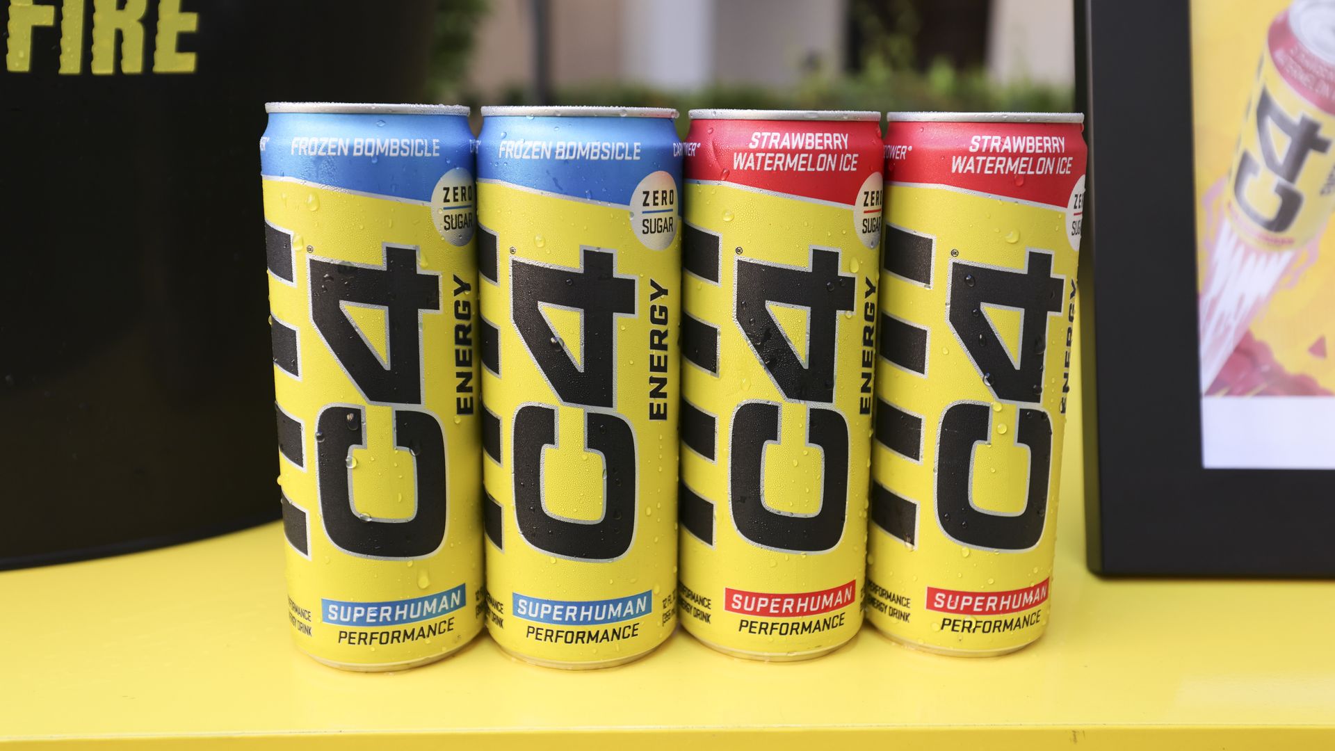 Cans of C4 Energy drink are displayed on a table.