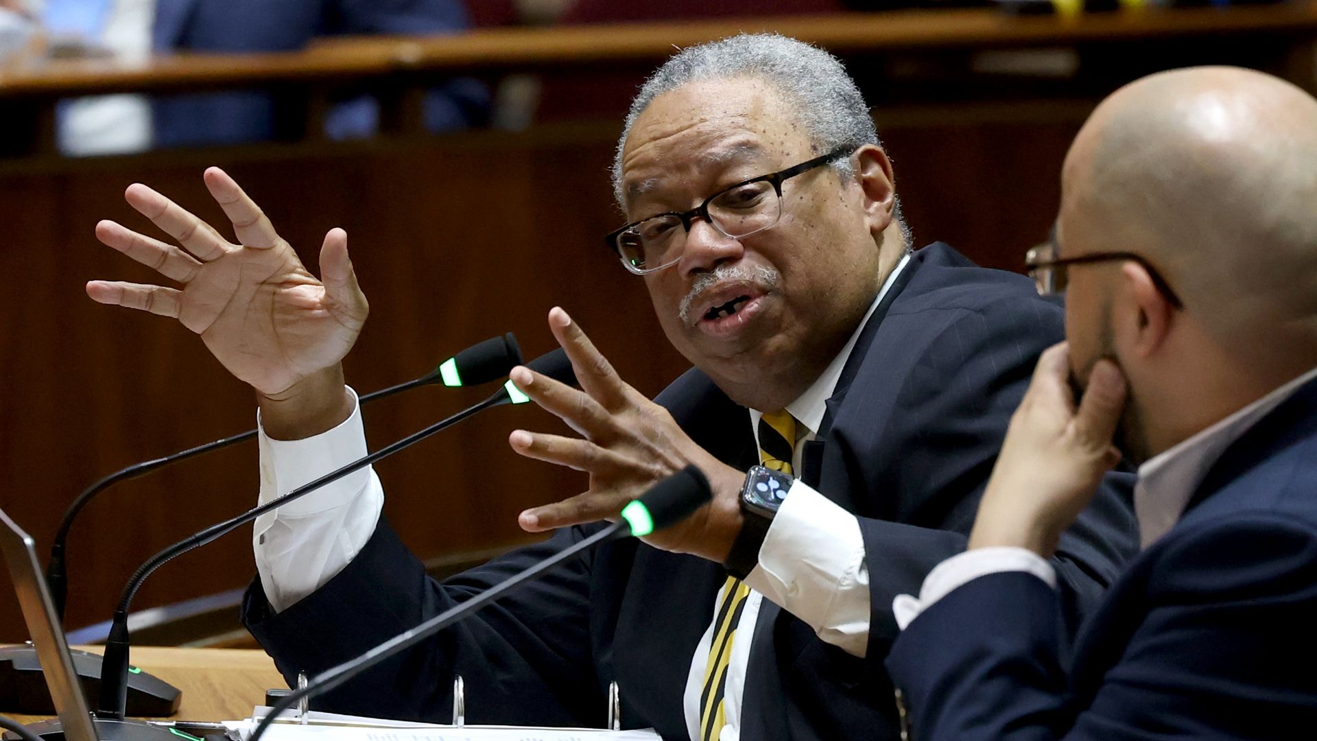 Photo of a man talking into a microphone 