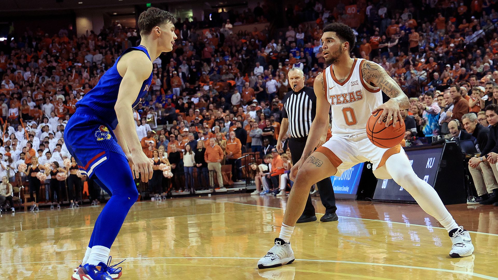 UT and Kansas basketball players square off on the court.