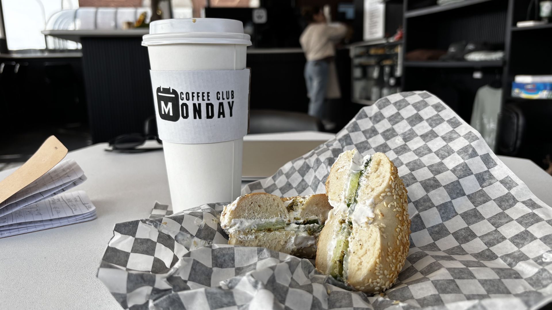 A cup of coffee and Mediterranean bagel from Monday Coffee Club.