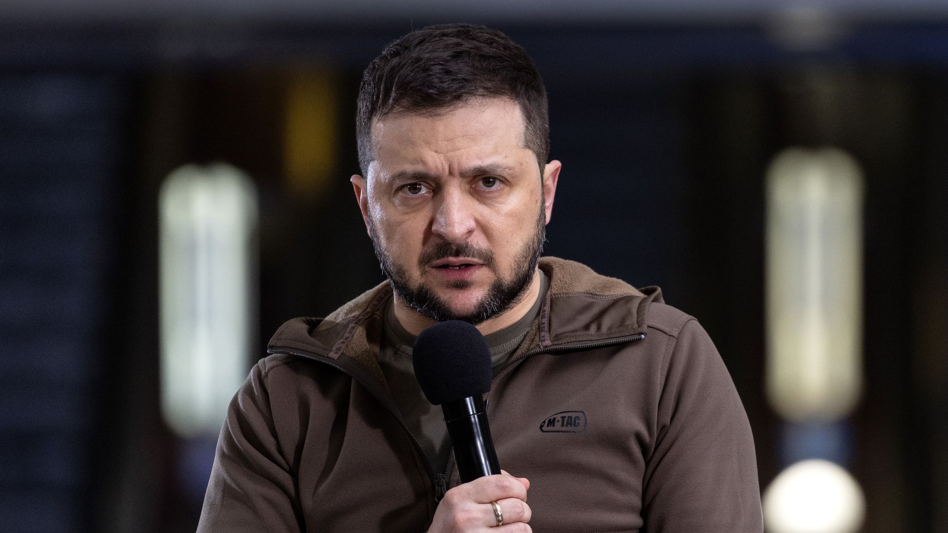 Photo of Volodymyr Zelensky speaking into a mic