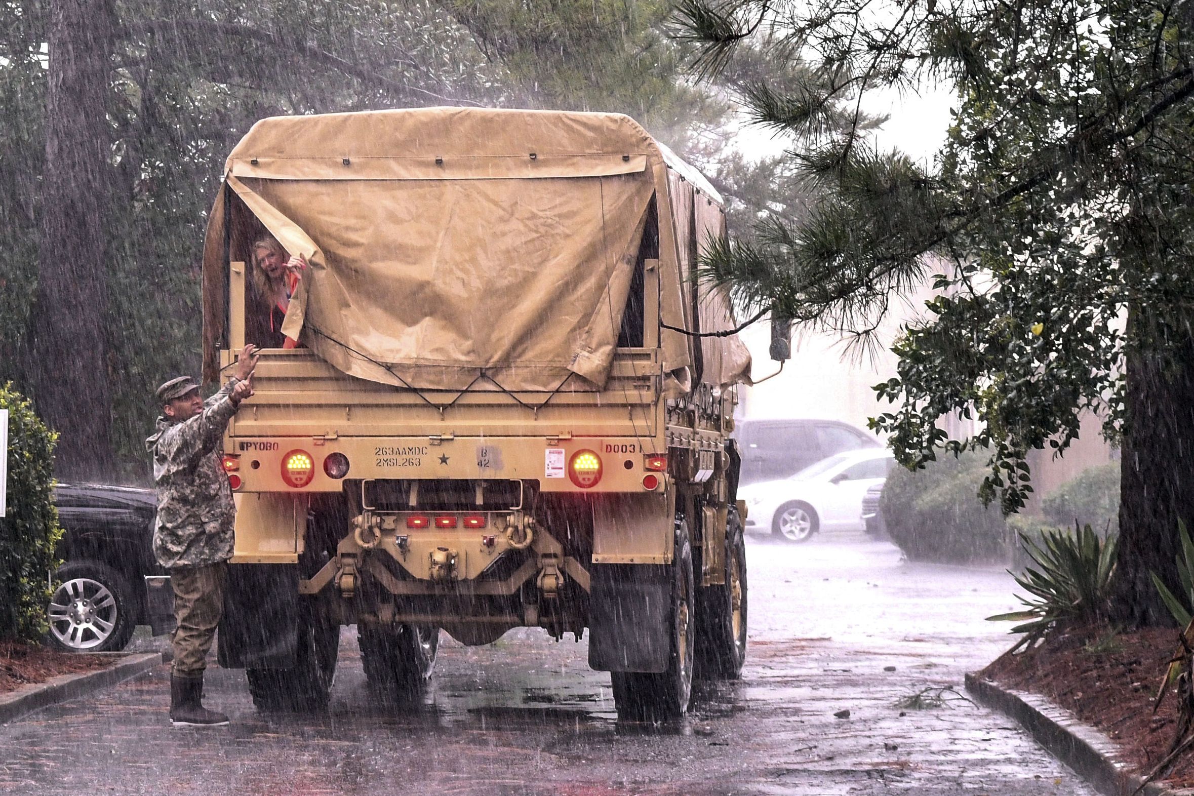 National Guardsmen cover truck in Hurricane Dorian