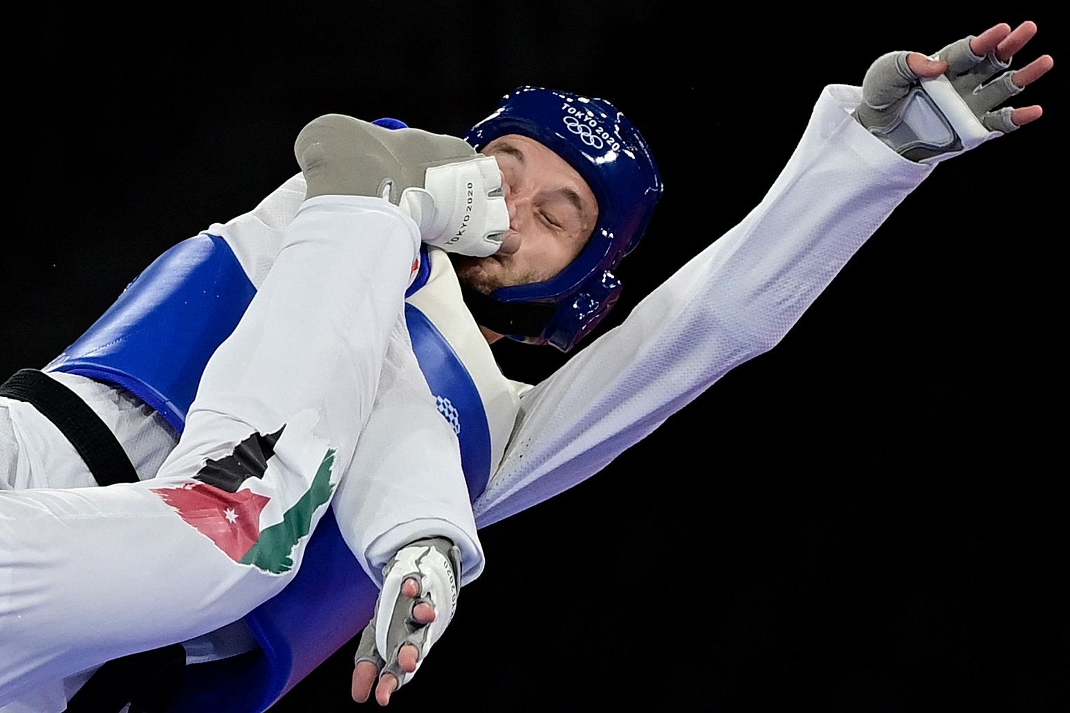 Norway's Richard Andre Ordemann (Blue) and Jordan's Saleh Elsharabaty (Red) compete in the taekwondo men's -80kg elimination round in Tokyo at the Olympics