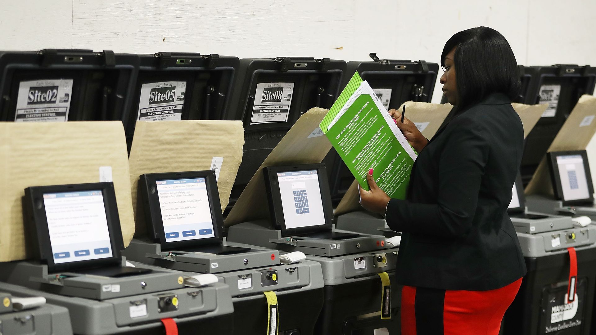 Woman checking voting booths