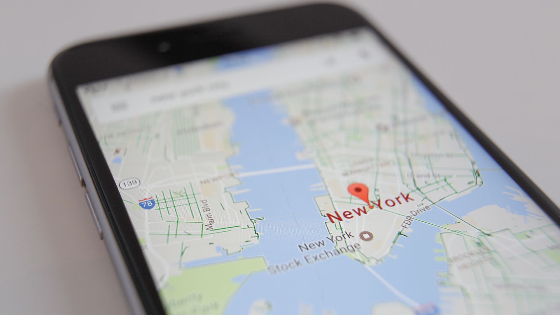 iPhone screen with Google Maps centered on Manhattan