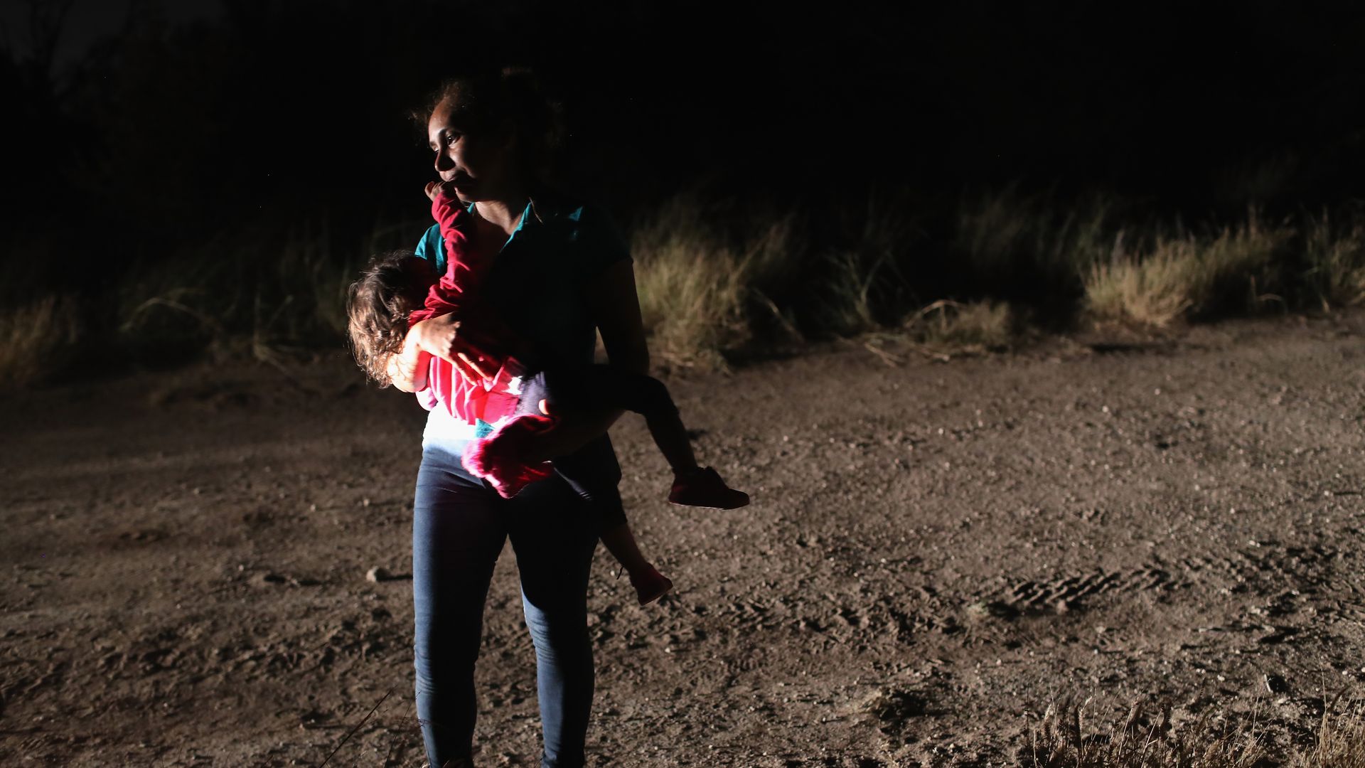 Border patrol agents detaining migrants 