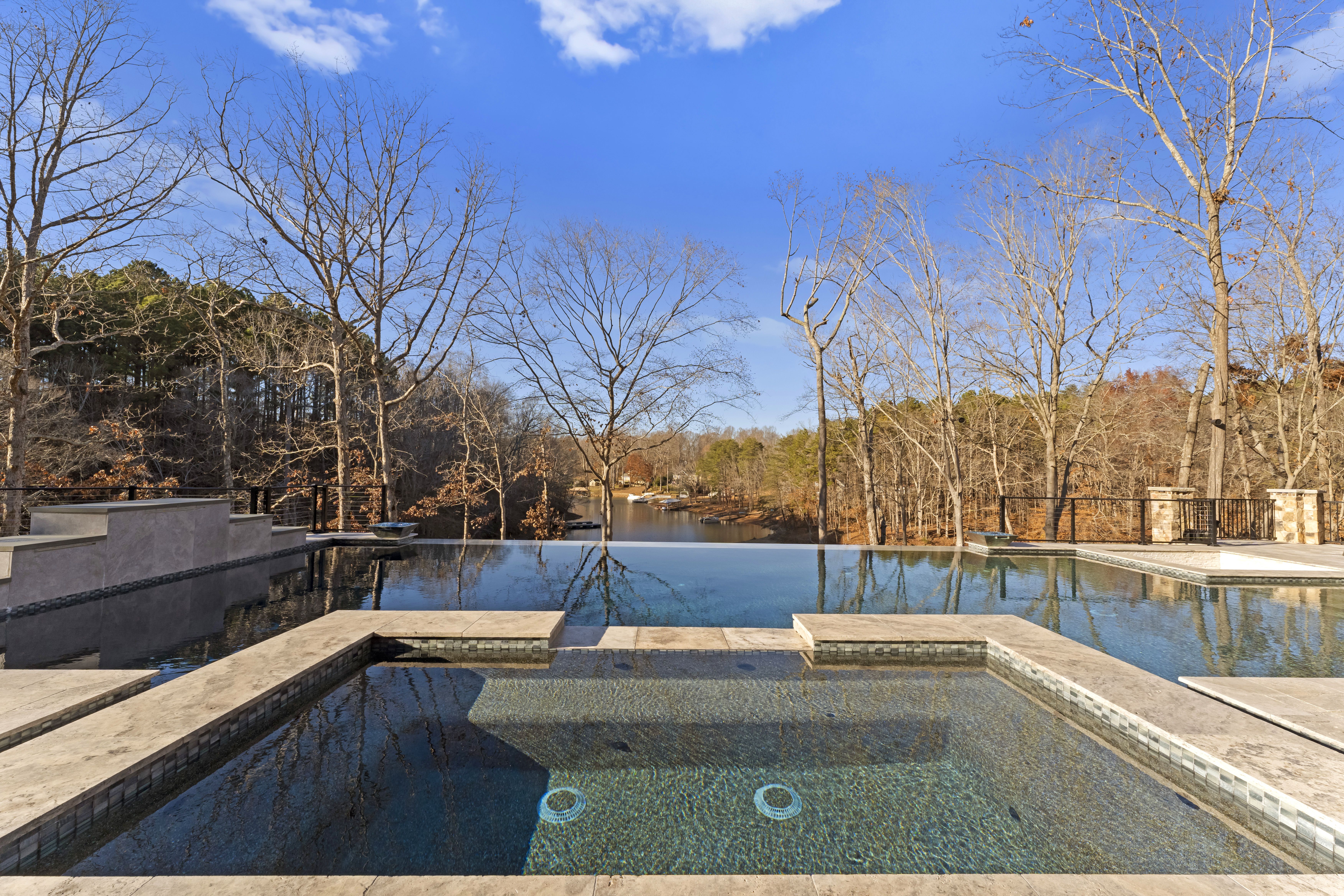 lakefront pool with infinity edge and hot tub