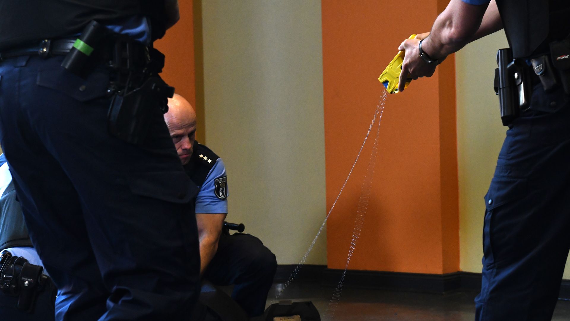 Photo of a police officer testing a Taser