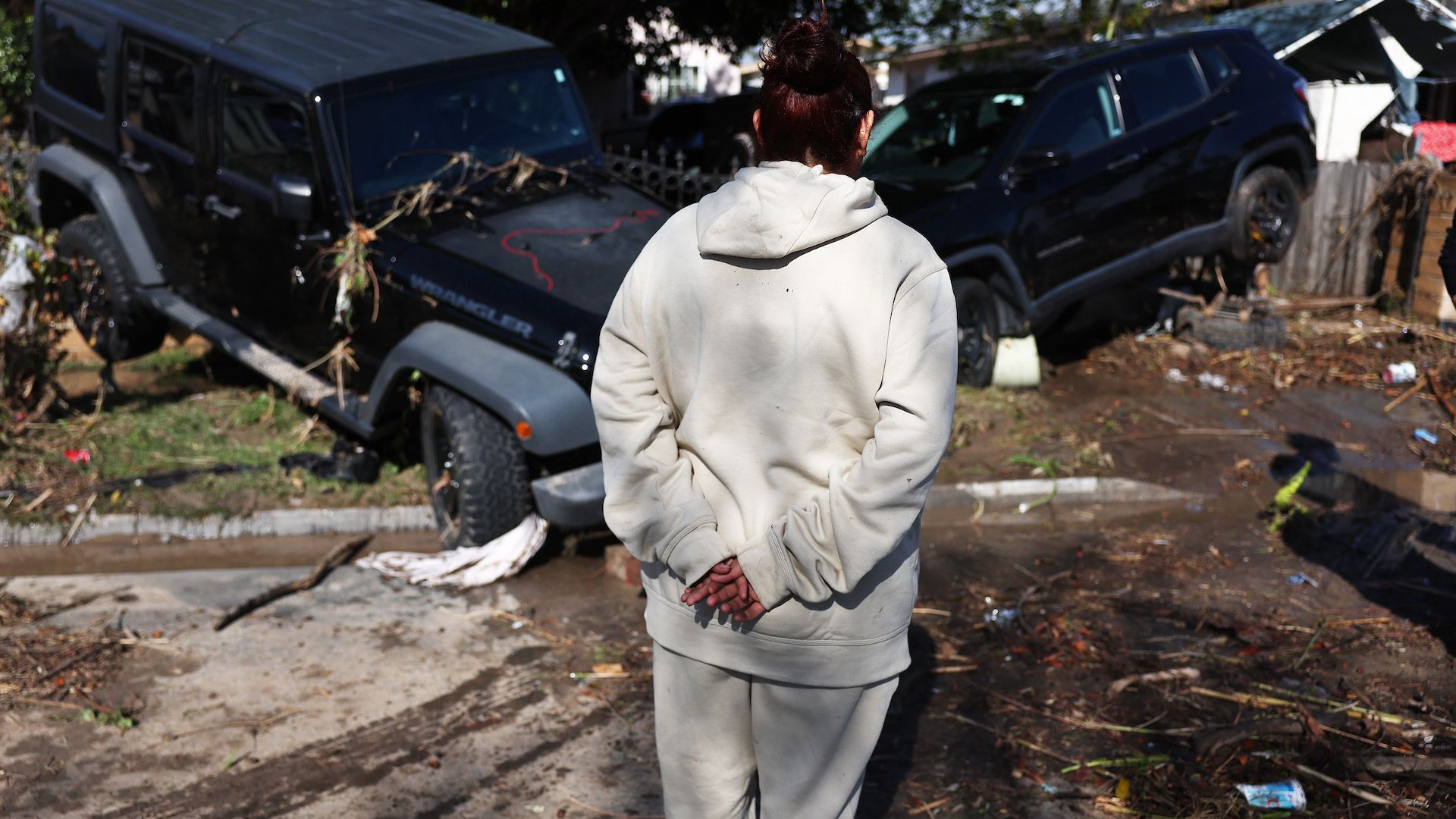 A southeastern San Diego resident surveys the damage from the Jan. 22 flood