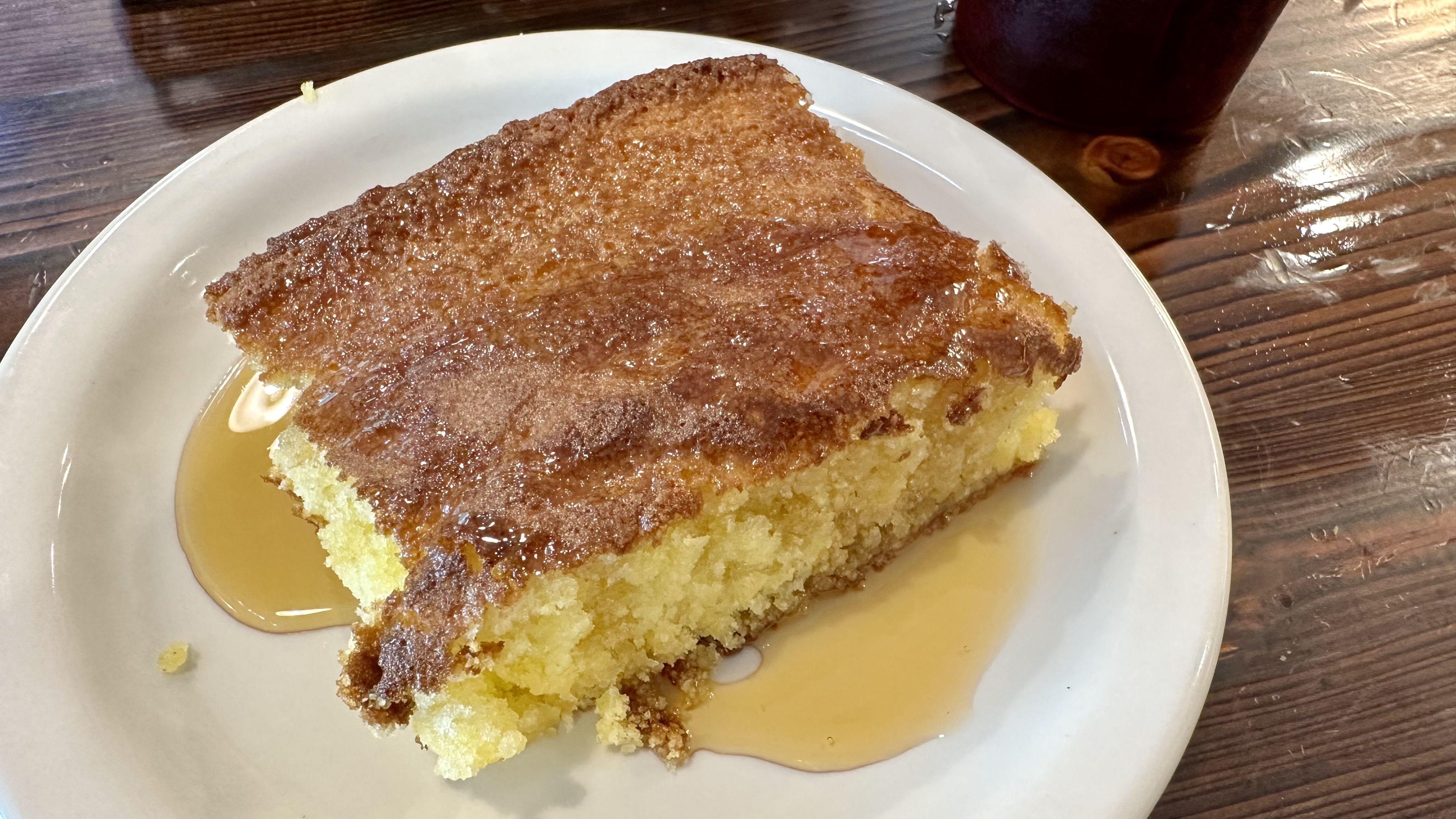 Photo shows a plate of cornbread with honey.
