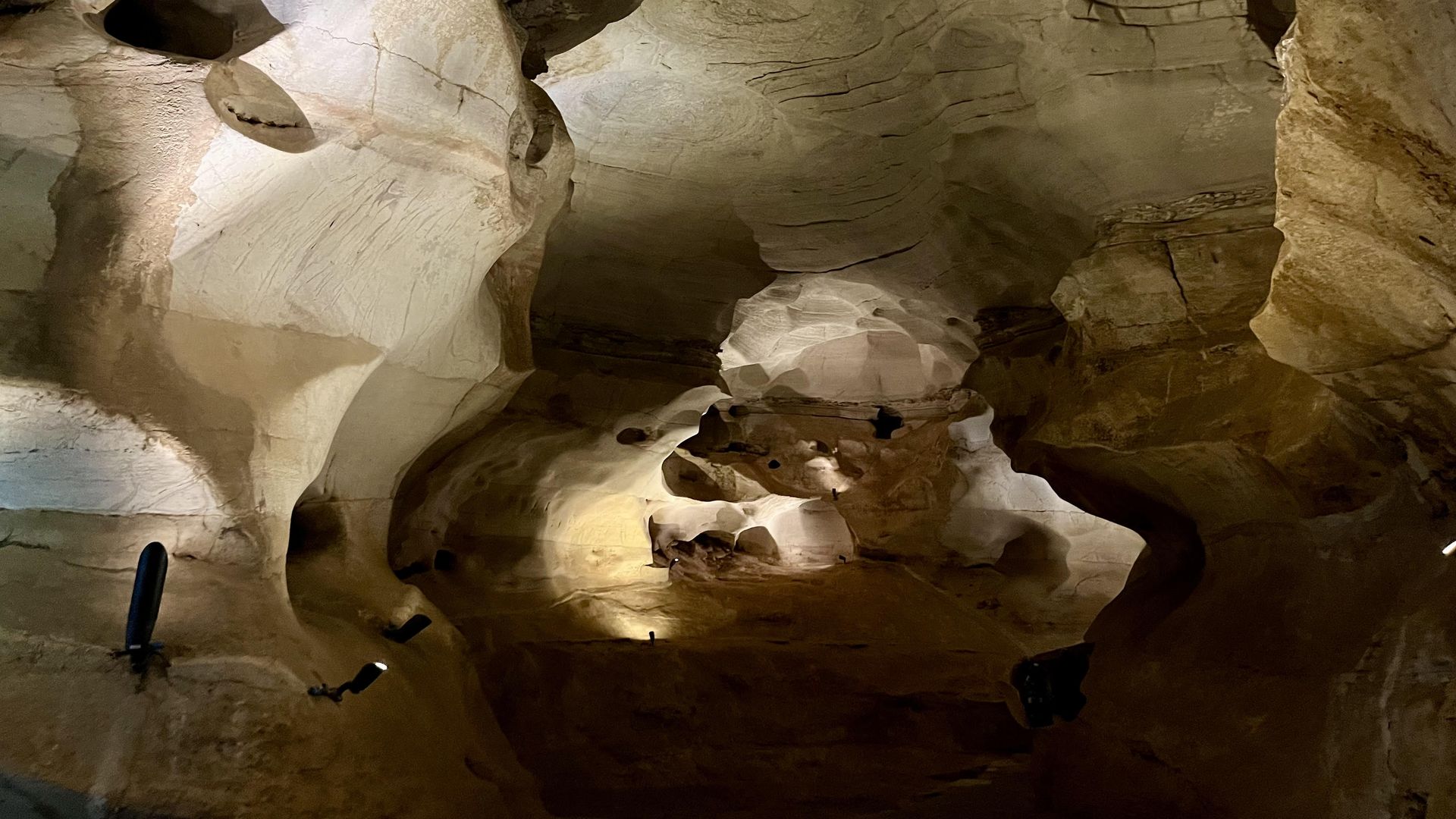 Longhorn Cavern is shown illuminated by lights against smooth walls.