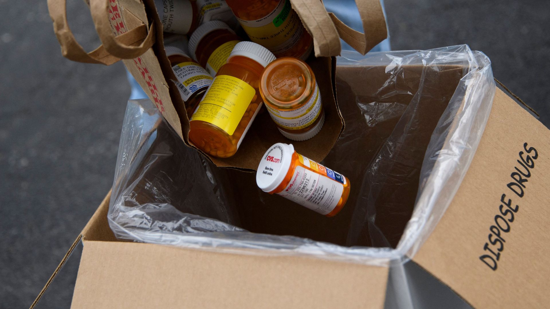 A bag of prescription drugs being poured into a box at a drug reclamation event organized by the Drug Enforcement Administration in Los Angeles in 2021.