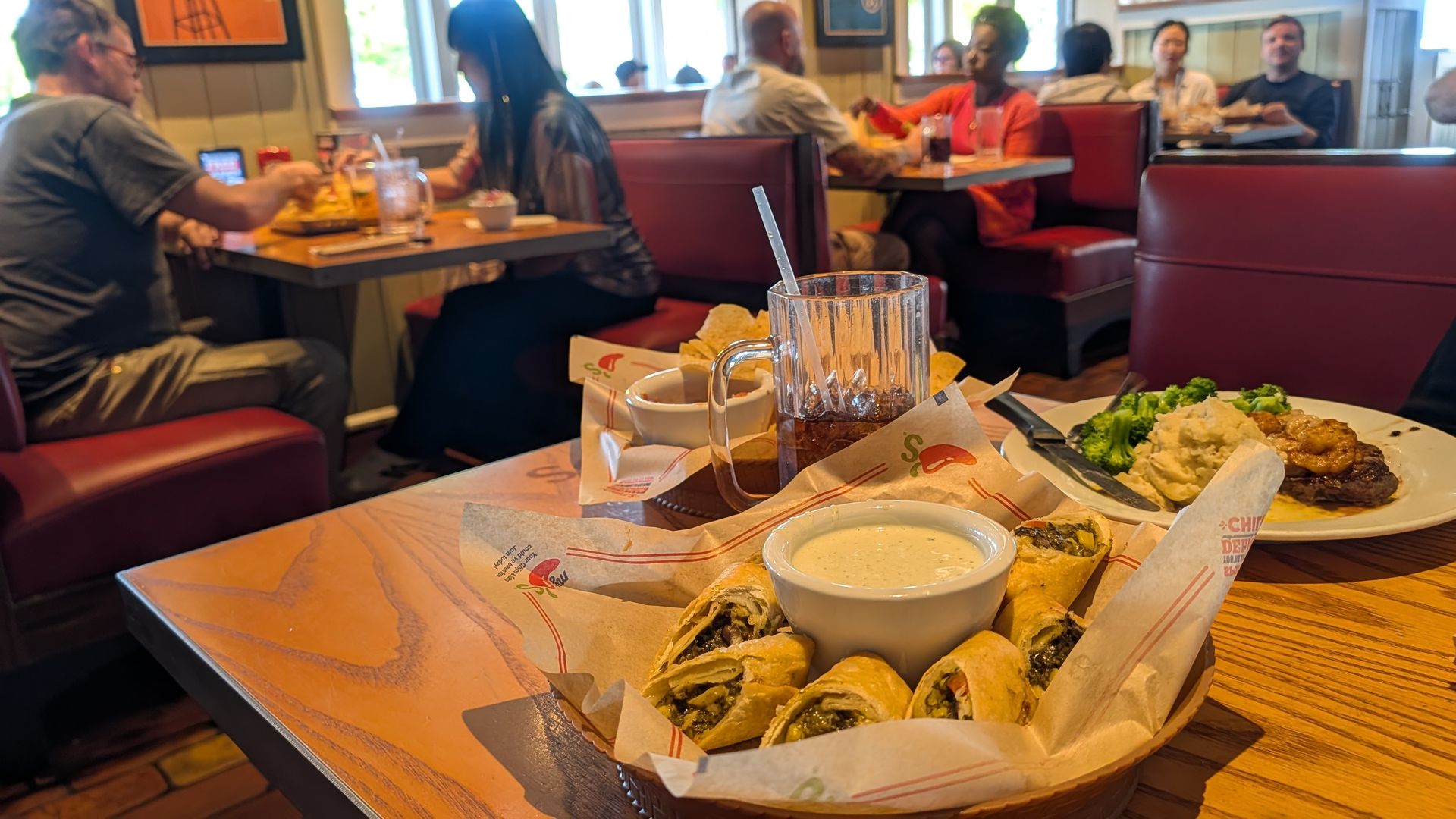 Food on a restaurant table with other diners in the background
