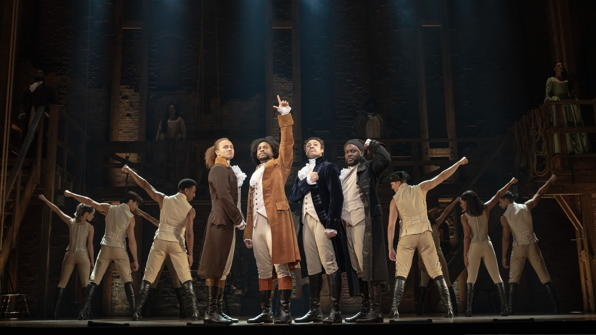 The caste of "Hamilton" performs on stage. 
