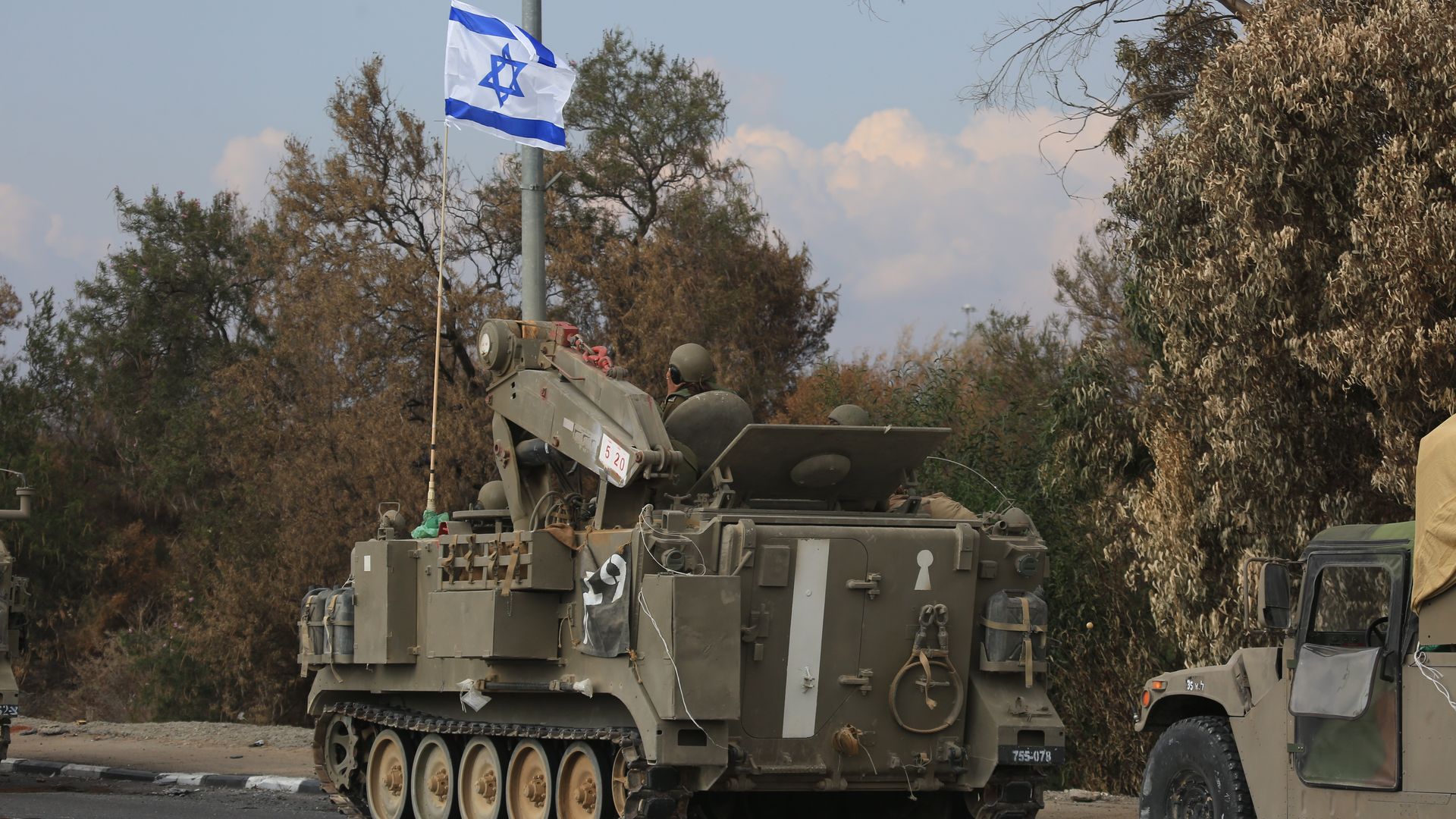 And Israeli soldier drives an army tank near the Gaza border. 