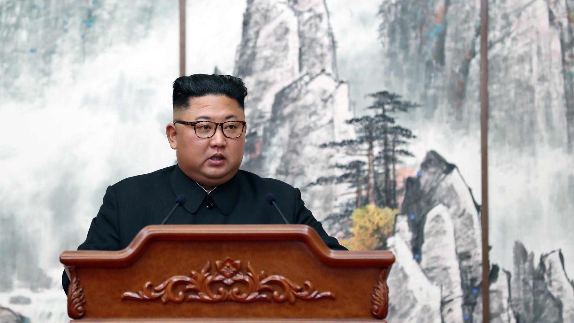 North Korean leader Kim Jong-Un speaking at a podium