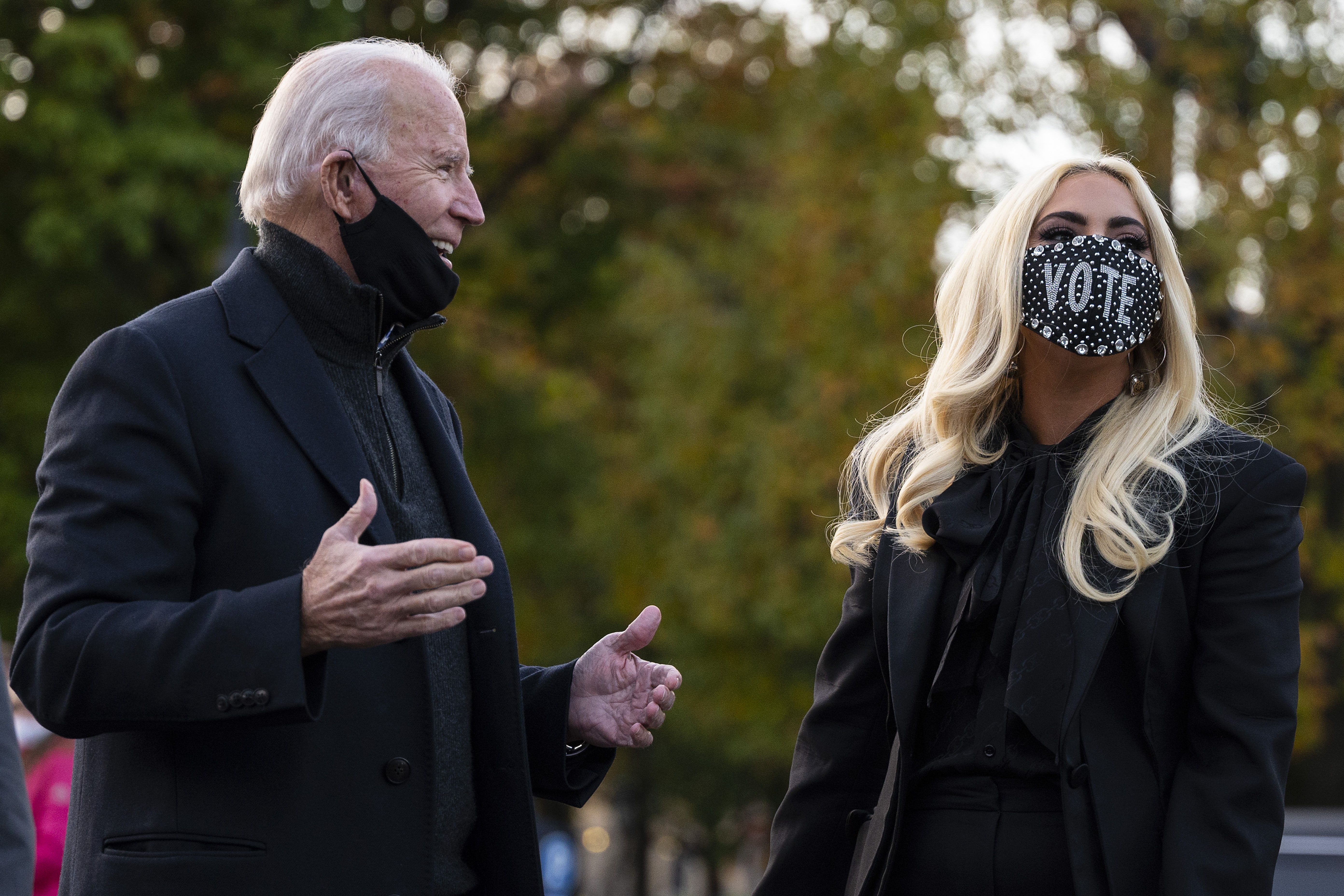 Democratic presidential candidate Joe Biden speaks with Lady Gaga before a drive-in rally in Pittsburgh, Pennsylvania on November 2