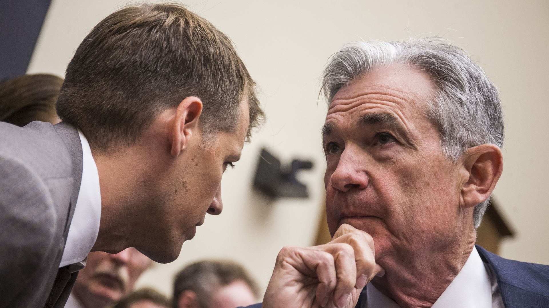 Federal Reserve Chairman Jerome Powell speaks to an aide before testifying during a House Financial Services Committee hearing on Capitol Hill.