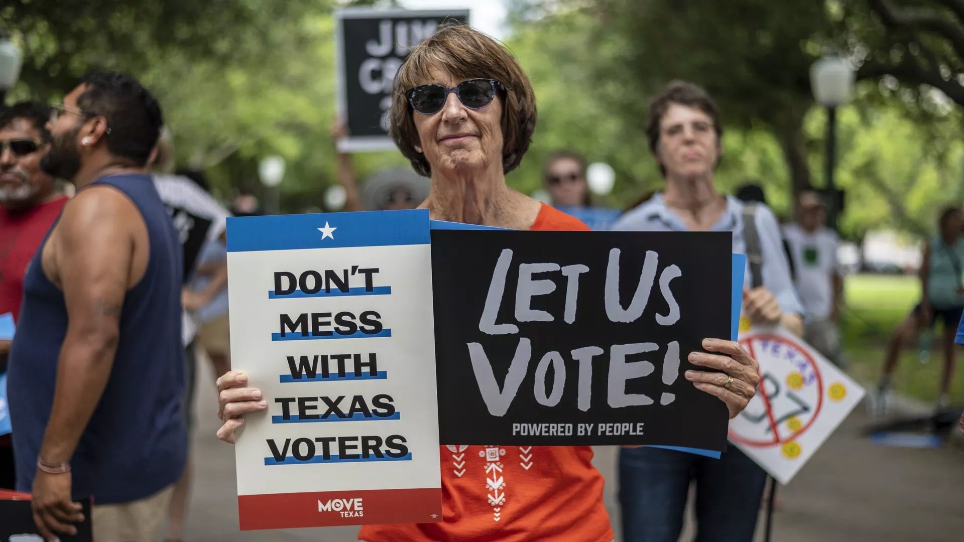 A woman is seen holding a sign at a Texas voting rights rally.