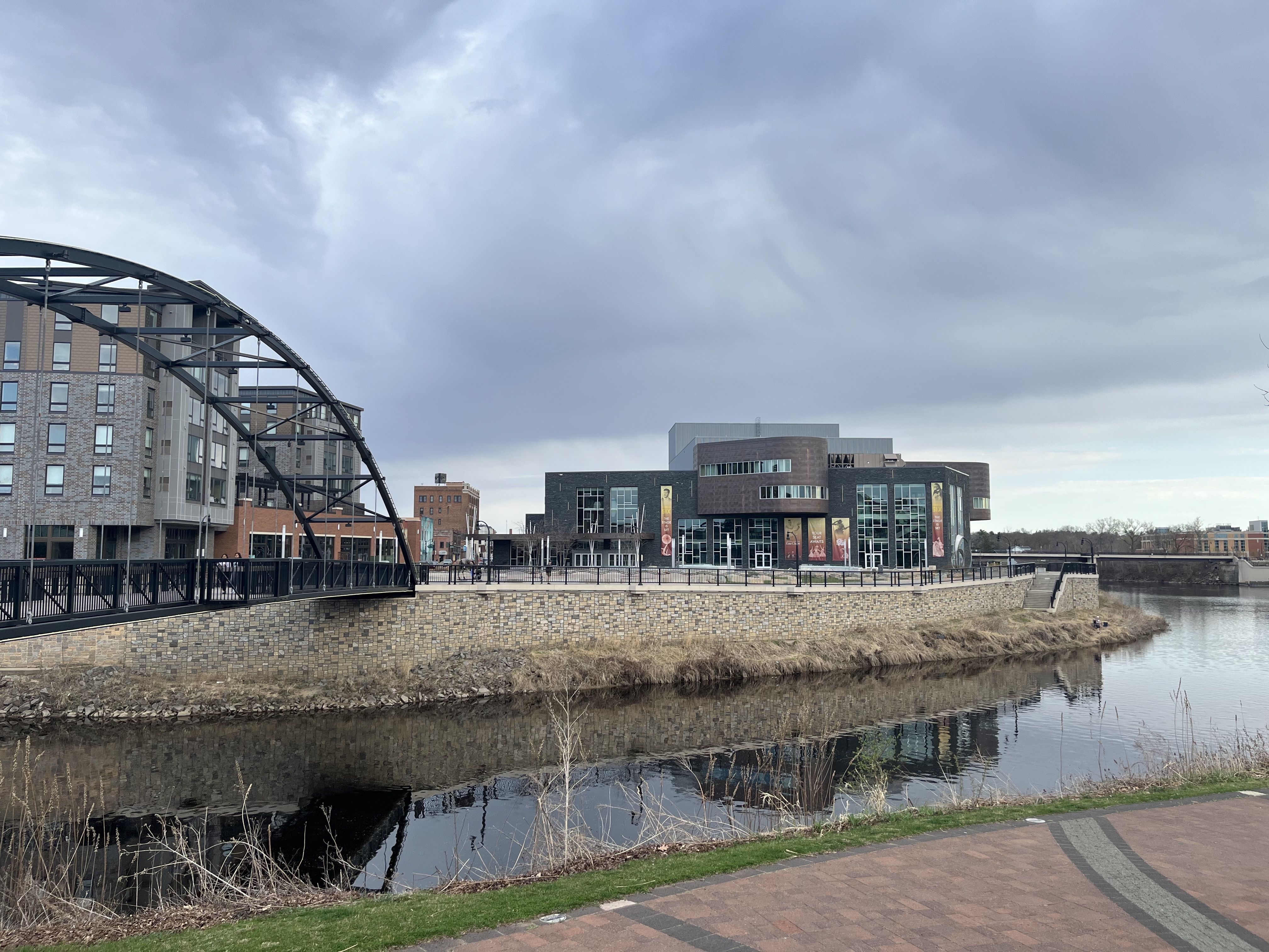 Phoenix Park with a bridge over a creek and a music venue in the background 