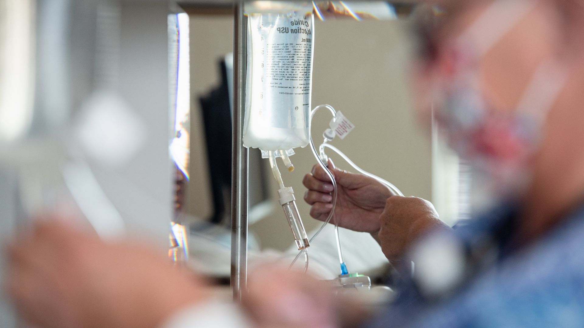 An image of a medical professional and an IV drip