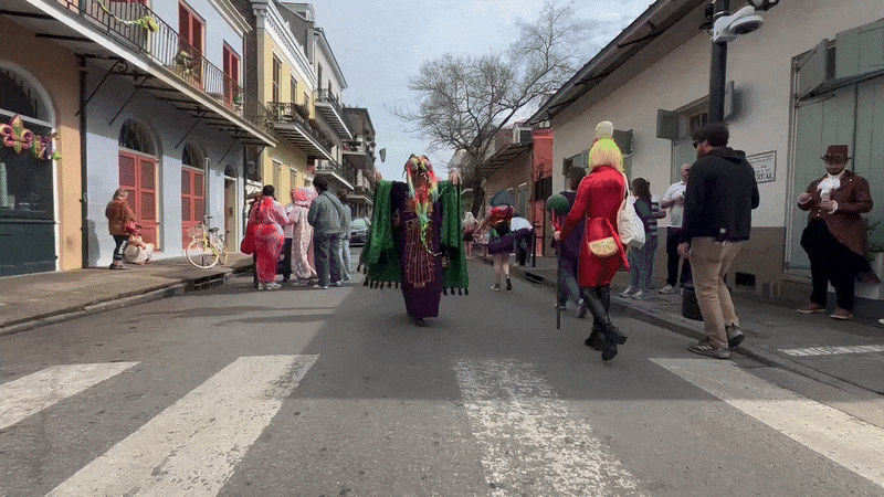 A person dressed lik ea monster runs to the camera and flashes their open hands toward it.