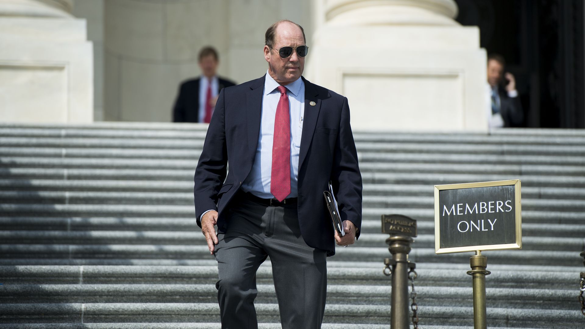 Ted Yoho walks down stairs.