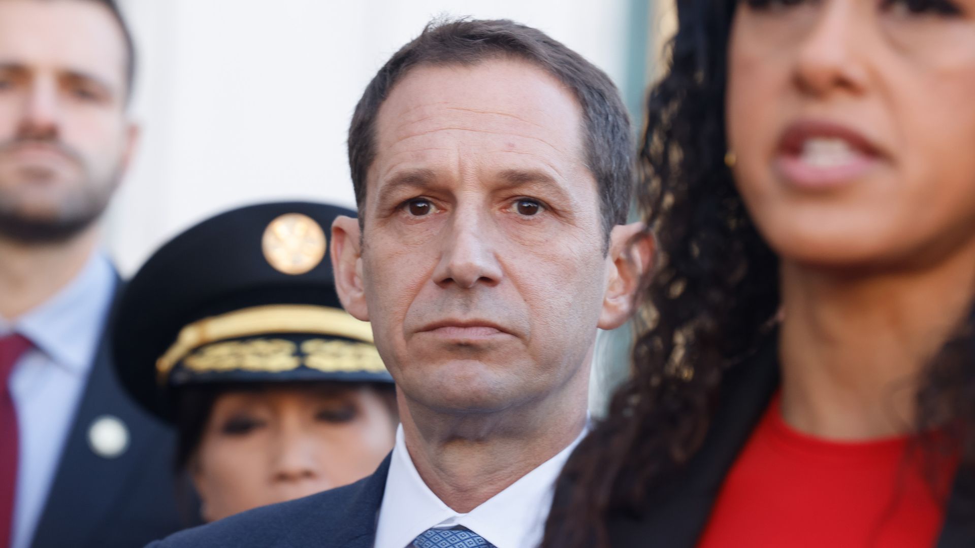 Photo of Daniel Lurie standing behind Brooke Jenkins