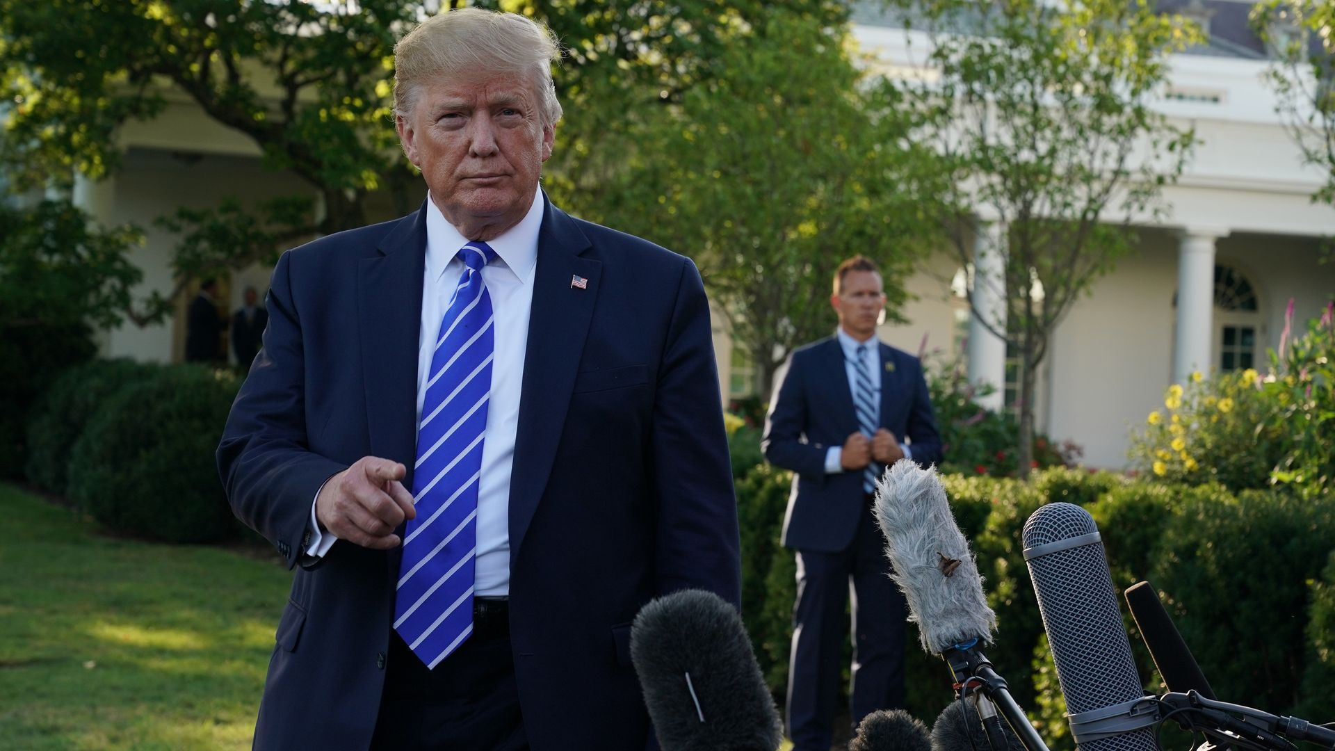 U.S. President Donald Trump speaks to members of the media prior to his departure for Camp David