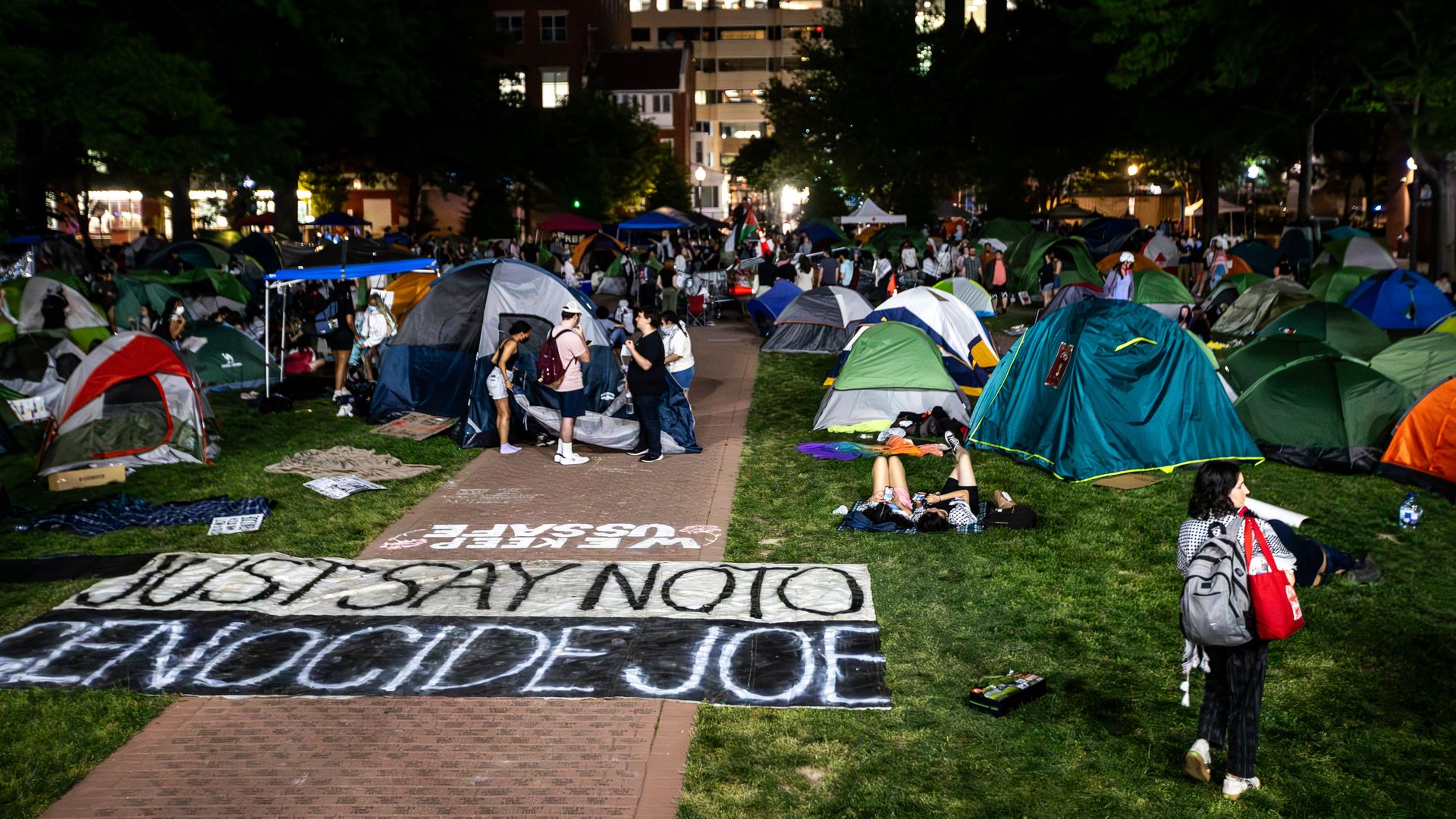Tents on George Washington University's campus with a sign saying "JUST SAY NO TO GENOCIDE JOE"