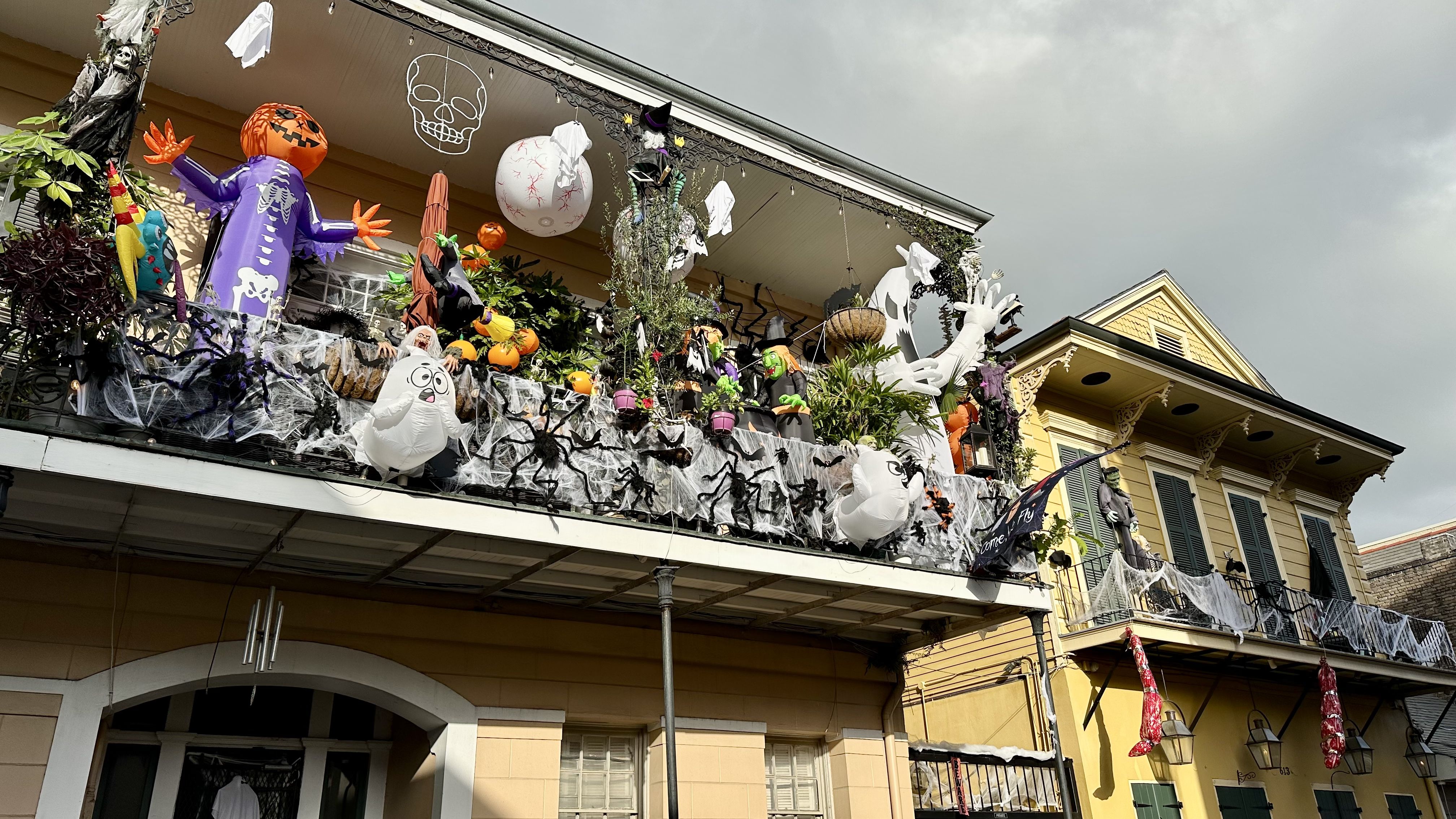 Photo shows French Quarter balconies decorated for Halloween.