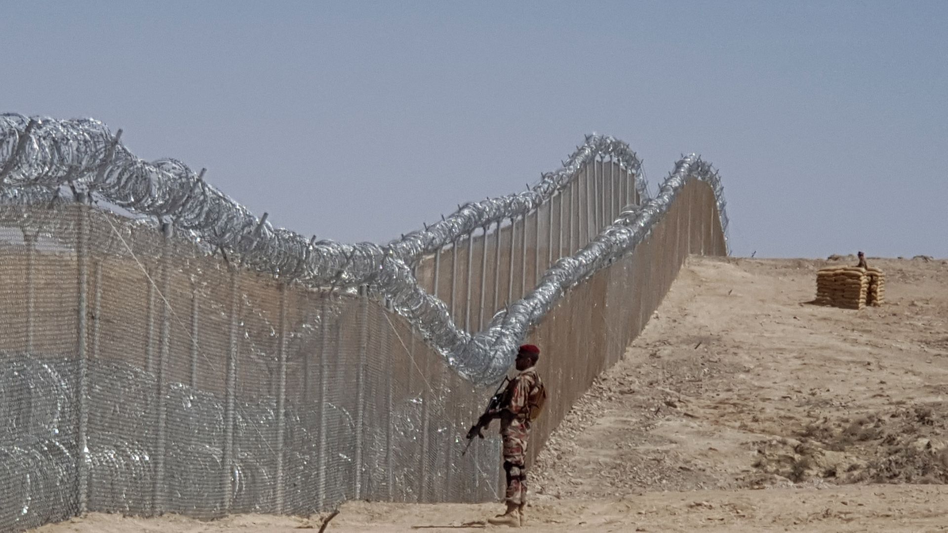 A Pakistani army soldier stands guard along with border fence at the Pak-Afghan border near the Punjpai area of Quetta in Balochistan on May 8, 2018. 