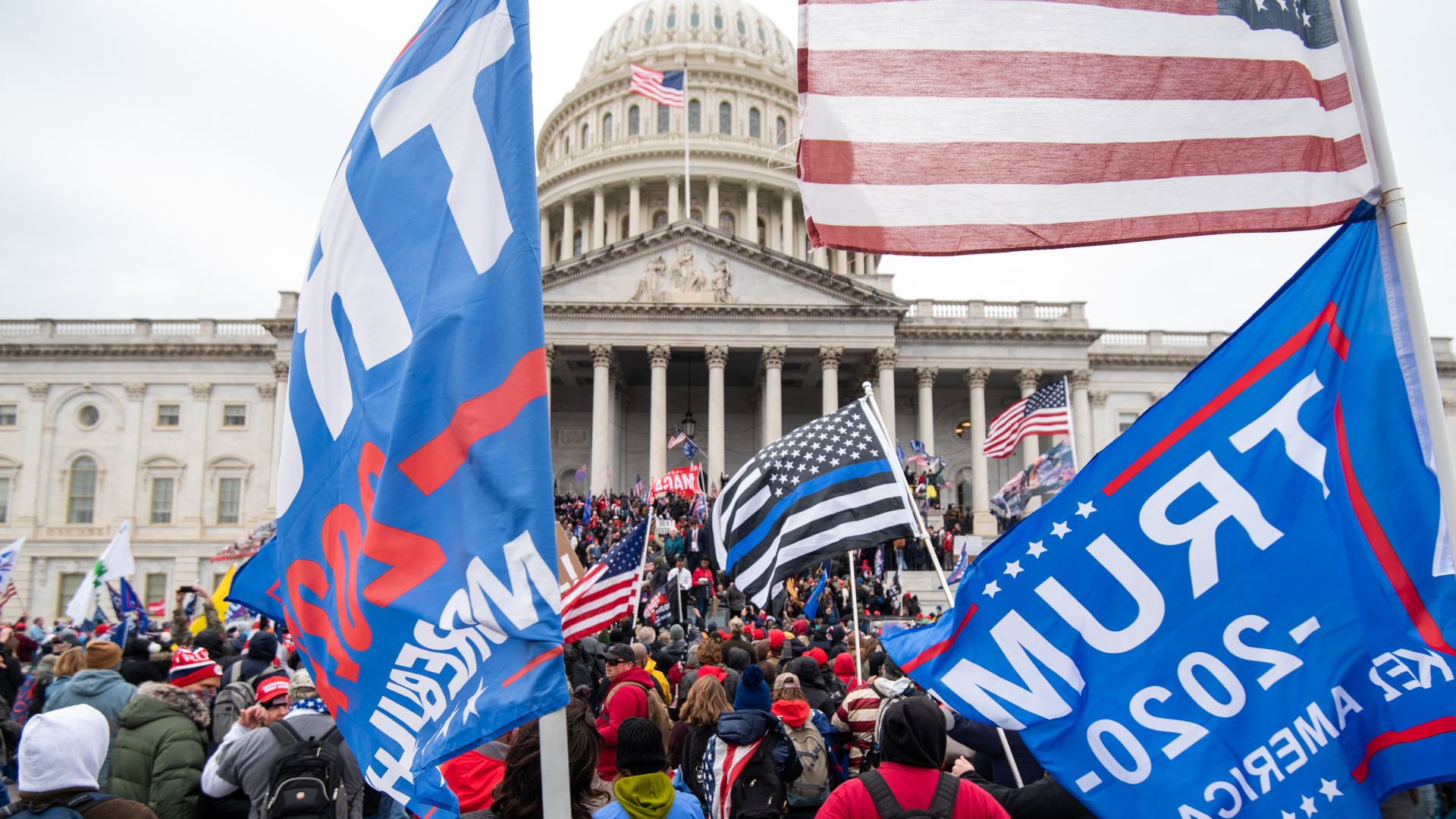 People carry Trump flags during the Jan. 6, 2021, riots outside the U.S. Capitol