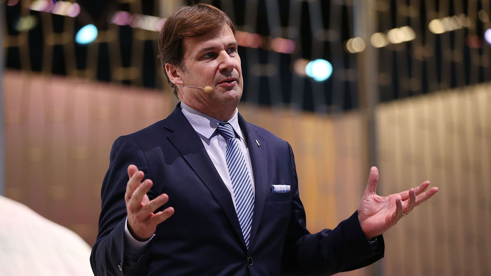 Image of incoming Ford CEO Jim Farley speaking at an auto show