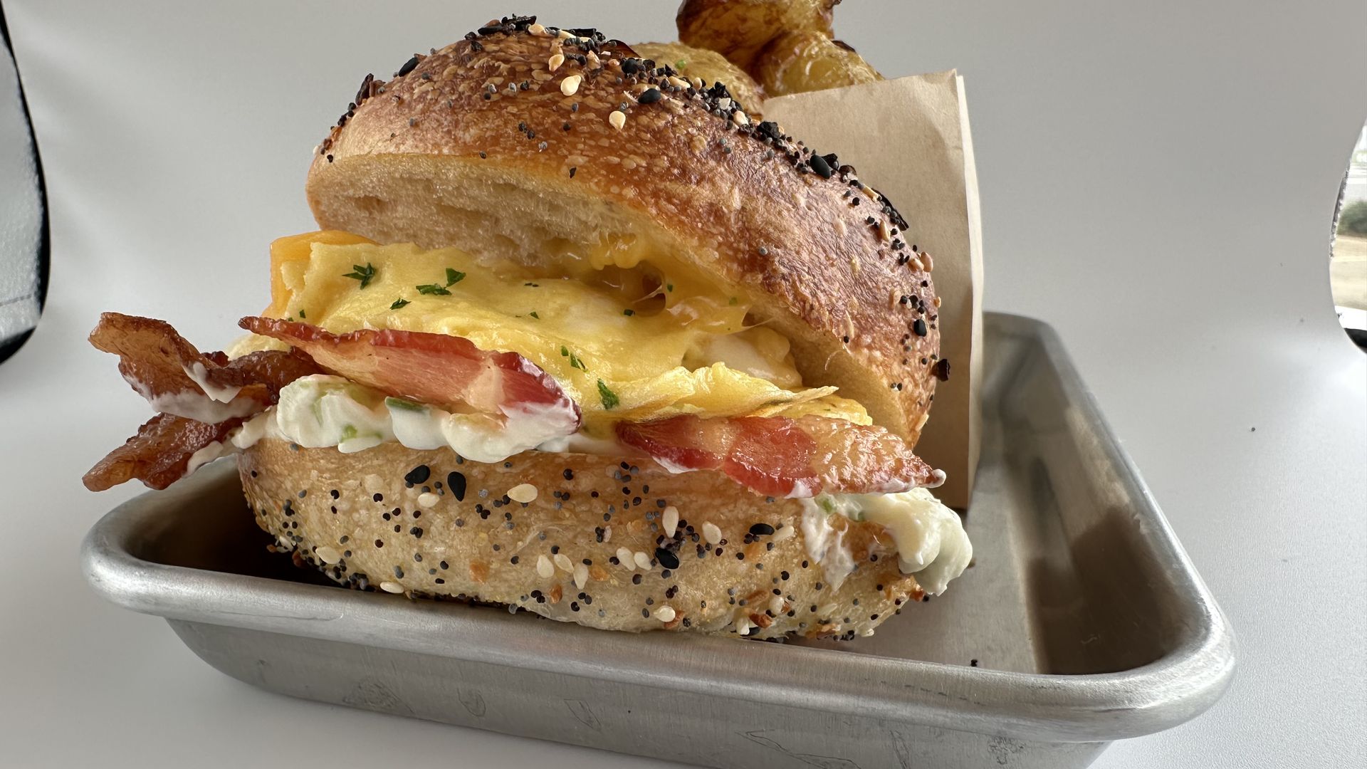 A bacon egg and cheese everything bagel sandwich 