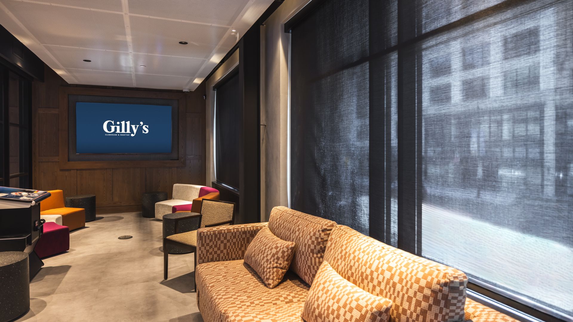 A view of couches inside Gilly's with large windows looking out onto the street.