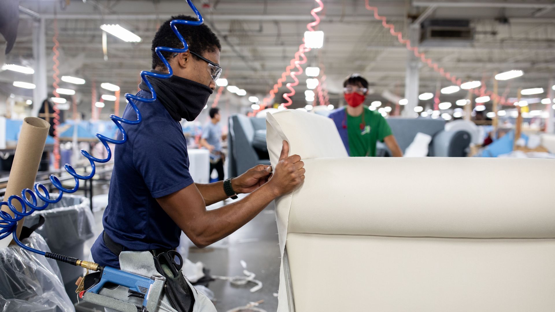 A worker upholsters a sofa at the Craftmaster Furniture manufacturing facility in Hiddenite, North Carolina, U.S., on Friday, Nov. 12, 2021. The U.S. Census Bureau is scheduled to release business inventory figures on March 16. Photographer: Logan Cyrus/Bloomberg via Getty Images
