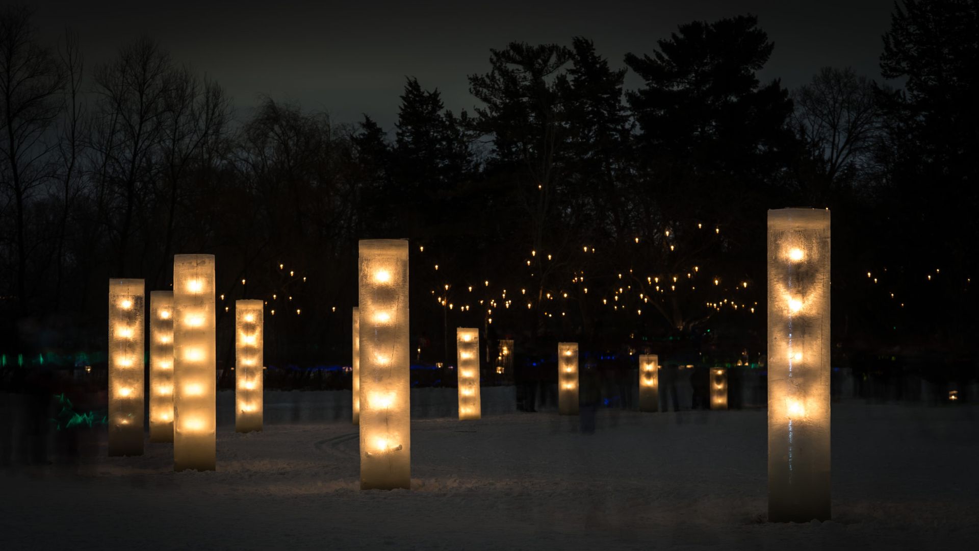 A photo of pillars of ice lit from within at night.